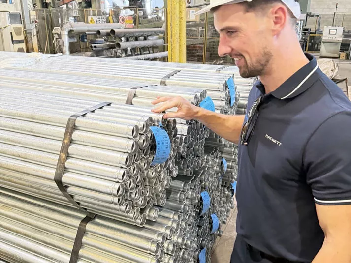 Steel Traders reviewing galvanised steel tube during a European mill visit